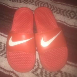 Lightly used orange Nike slides